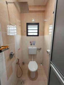a small bathroom with a toilet and a shower at B&B By JumStay in Sepang +36 photos
