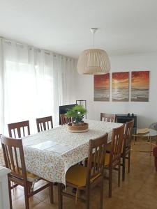 a dining room with a table and chairs at CASA AMELIA Apartamentos in Padrón