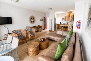 a living room with a couch and a table at Jetty Seaview Apartment in Swakopmund