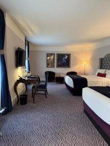 a hotel room with two beds and a desk at Hotel kalyan near by Delhi igi airport free Pickup in Etāwah