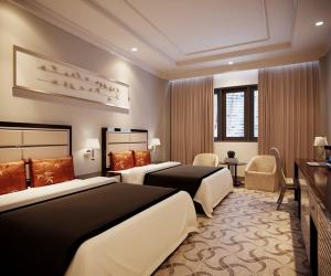 a hotel room with two beds and a television at Hotel kalyan near by Delhi igi airport free Pickup in Etāwah