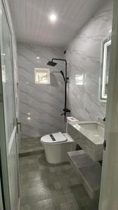 a bathroom with a toilet and a sink at Hotel kalyan near by Delhi igi airport free Pickup in Etāwah