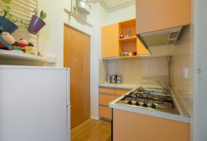 a kitchen with a sink and a stove top oven at Apartment Witty Please in Zagreb