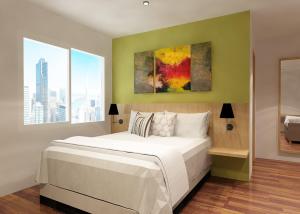 Een bed of bedden in een kamer bij Front One Hotel Jayapura +24 foto's