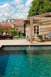 a swimming pool in front of a house at La maison de Céline in Arry