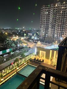 a view of a city at night with a swimming pool at The Novaire in Lucknow