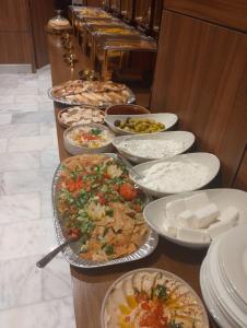 a buffet with many plates of food on a table at فندق الوعل بالخفجى in Khafji