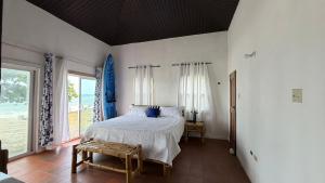 a bedroom with a bed and a large window at YAI Wellness Oasis in Yallahs
