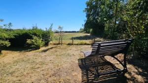 a park bench sitting in the middle of a field at Chalet in Freilingen Blankenheim mit Seenähe mitten in der Natur in Blankenheim