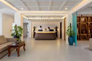 a lobby with two people working at a desk at THE RIVERFRONT CENTRAL Hotel in Siem Reap +79 photos