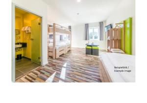 a room with a bed and a room with a kitchen at Hostel Art & Style in Singen