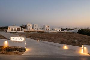 a view of a row of white buildings at night at Eupnoia Villas in Agios Arsenios
