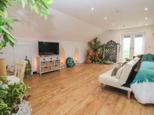 a large living room with a couch and a television at The Retreat in Goole