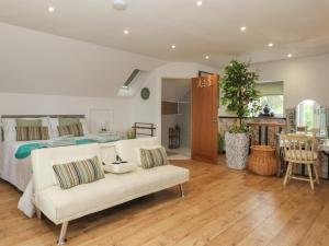 a living room with a white couch and a bed at The Retreat in Goole