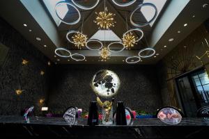 a room with a chandelier and a table with a trophy at King's Mansion in Candolim +37 photos