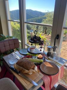 a table with food on it with a window at Quinta das Riquezas in Dornes