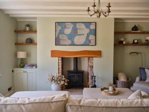 a living room with a couch and a fireplace at 27 West Green in Newton Aycliffe
