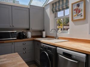 a kitchen with a sink and a dishwasher at 27 West Green in Newton Aycliffe