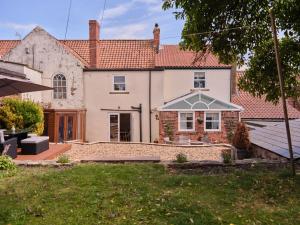 an external view of a house with an umbrella at 27 West Green in Newton Aycliffe