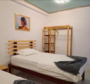 a bedroom with two beds and a painting on the wall at Gk Eleven in Himmafushi