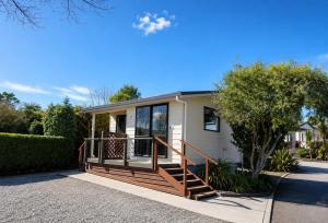 a manufactured home with a porch and a deck at Taupo Debretts Spa Resort in Taupo