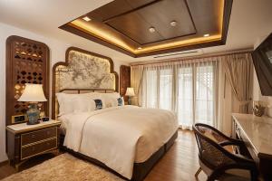 a large bedroom with a large bed and a table at CHINO@NIMMAN Luxury Boutique Hotel in Chiang Mai +25 photos