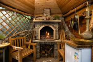 a fireplace in a log cabin with a chair at K Suites - Liverpool Road Worcester with Hot Tub in Worcester
