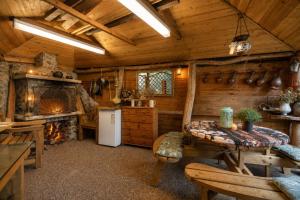 a log cabin kitchen with a table and a refrigerator at K Suites - Liverpool Road Worcester with Hot Tub in Worcester +17 photos