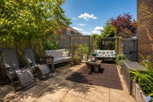 a patio with two chairs and a table at K Suites - Liverpool Road Worcester with Hot Tub in Worcester