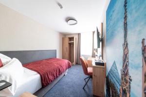 a hotel room with a bed and a desk at Krone 1516 in Elchingen