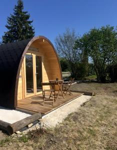 a small dome tent with a chair on a deck at Cabane - Nature & Détente in Lavoncourt