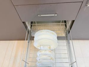 a metal rack with four towels in a kitchen at AeroNest Homes - 1BHK & 2BHK Quiet & Comfortable Near Airport 7km in Muthugadahalli