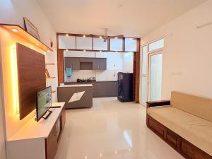 a living room with a couch and a kitchen at AeroNest Homes - 1BHK & 2BHK Quiet & Comfortable Near Airport 7km in Muthugadahalli +36 photos