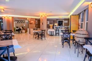 a restaurant with tables and chairs in a room at Siete Hotel in Antalya