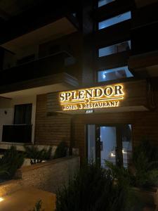 a hotel sign in front of a building at night at Hotel Restaurant Splendor in Buşteni