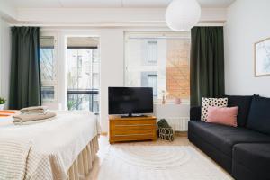 a living room with a bed and a couch at Central Studio 33m2 Sauna Wifi Parkkipaikka in Kuusamo