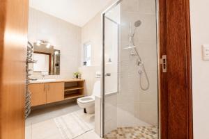 a bathroom with a shower and a toilet at Jetty Seaview Apartment in Swakopmund +2 photos
