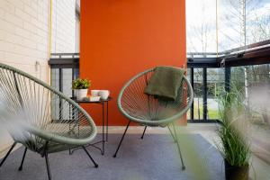 two chairs and a table on a patio at Central Studio 33m2 Sauna Wifi Parkkipaikka in Kuusamo