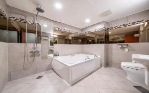 a bathroom with a tub and a toilet and a sink at Hotel The Fine in Uijeongbu +26 photos