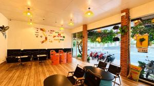 a restaurant with tables and chairs in a room at Q Song Chi Côn Đảo Hotel in Con Dao