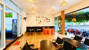 a room with chairs and motorcycles on the wall at Q Song Chi Côn Đảo Hotel in Con Dao