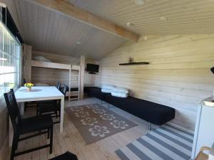 a room with a sauna with a table and a bench at Arctic Camping Finland in Pello