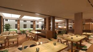 a restaurant with tables and chairs in a room at The Nishat Hotel Margala in Islamabad +42 photos