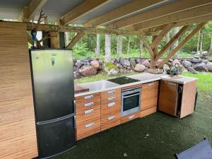 a kitchen with a refrigerator and a stove at Glamping Tent Tammemäe in Haapsi