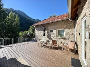 a patio with chairs and a table and a building at Chalet Villas Gerês in Geres