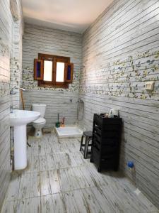 a bathroom with a sink and a toilet at Zaytouna camp Room 2 in Marsa Matruh