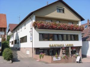 a building with flower boxes on the side of it at Hotel Lamm in Waiblingen