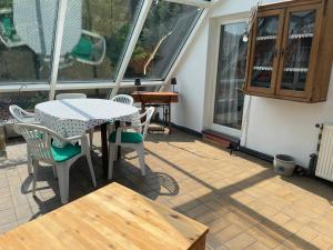a patio with a table and chairs and windows at To Huus bei Hanne 
