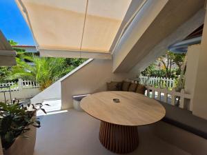 a wooden table in a room with a balcony at Vaios Luxury Apartments in Polychrono