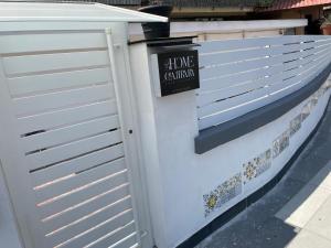a white fence with a sign on it at Home-Carrara in Naples